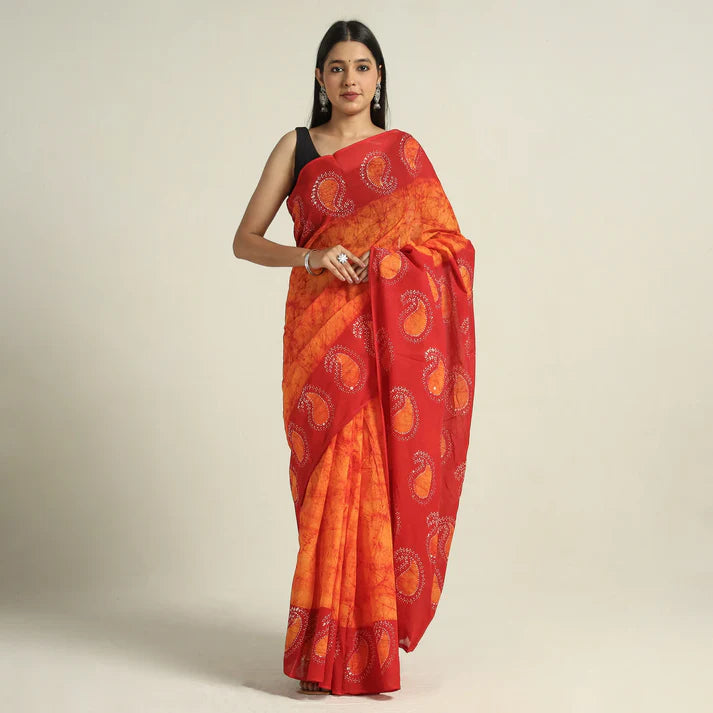 Plumvera hand batik cotton saree red and orange paisley print draped on model with black sleeveless blouse