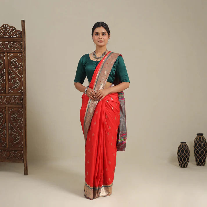 Plumvera model wearing red pure silk paithani saree with gold zari border and traditional motifs