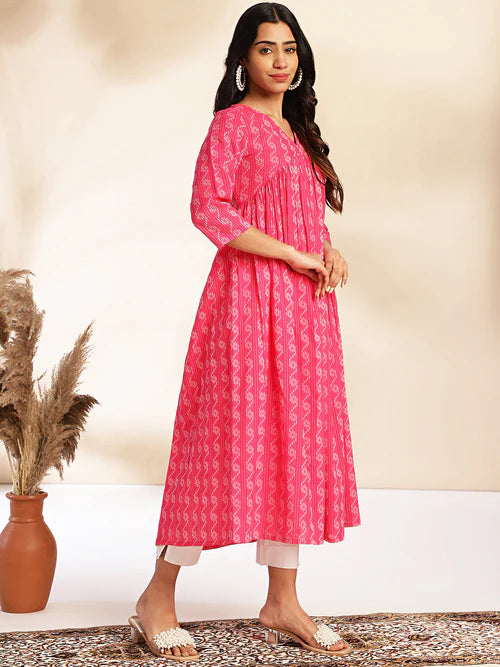 Plumvera model wearing pink cotton gathered kurta with three quarter sleeves pleated front paired with white pants