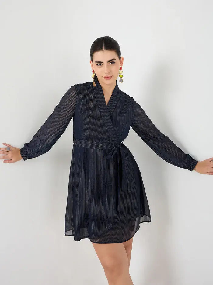 Femella navy belted mini dress with long sleeves and wrap style on model against white background