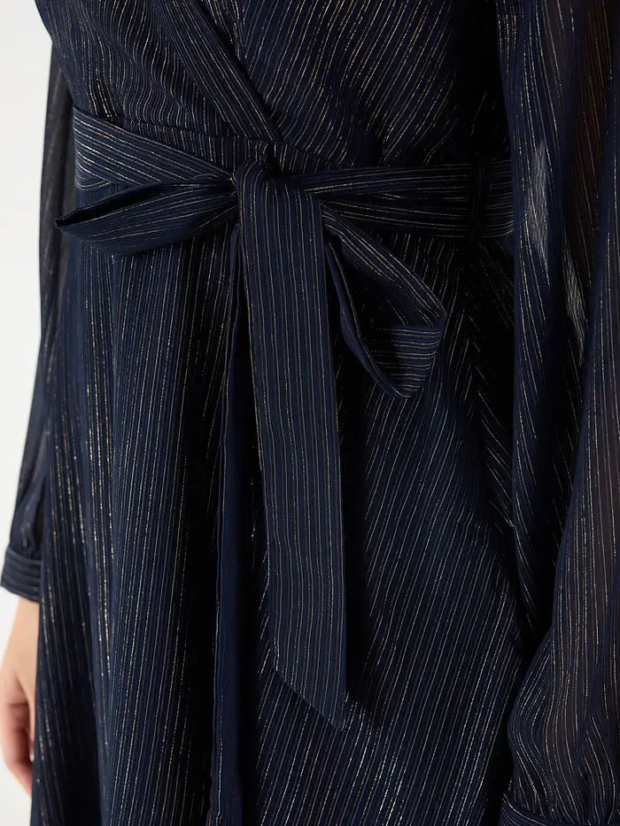 Close-up of navy belted mini dress with vertical metallic stripes and long sleeves from Femella