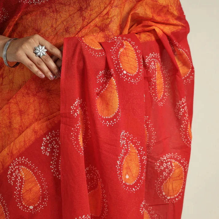 Plumvera hand batik cotton saree in red and orange with white dotted teardrop motifs draped on model