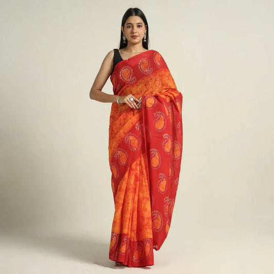 Plumvera hand batik cotton saree red and orange paisley print draped on model with black sleeveless blouse