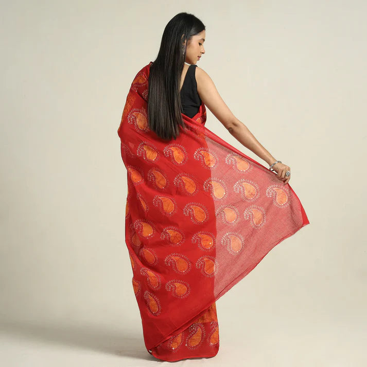 Plumvera red hand batik cotton saree with orange paisley motifs draped on model wearing black blouse