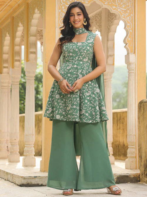 Model wearing a sage green georgette kurta set with floral print sleeveless top palazzo pants dupatta