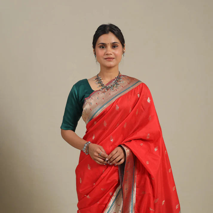 Plumvera model wearing red pure silk paithani saree with gold motifs and contrasting green blouse and traditional drape