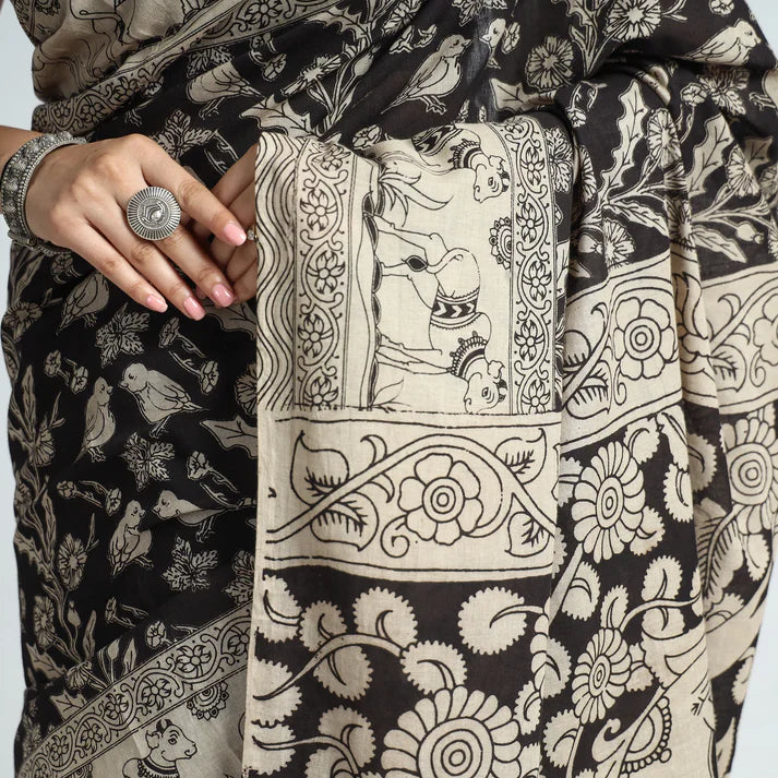 Plumvera black kalamkari cotton saree with beige floral and bird motifs closeup showing drape and silver ring