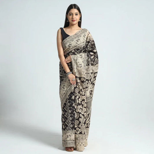 Plumvera black kalamkari cotton saree draped on model with beige floral traditional block print and black blouse
