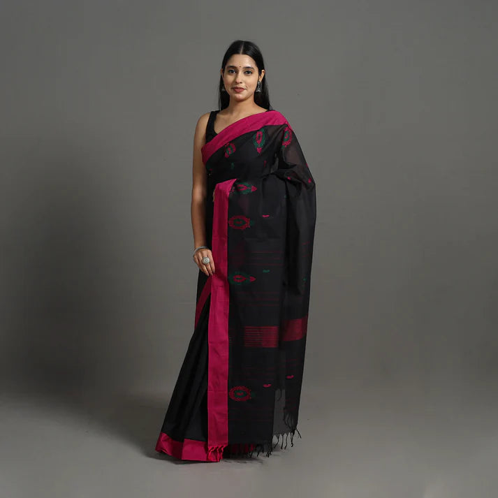 Plumvera model wearing a black kanchipuram cotton saree with magenta border and ikat motifs styled for festive occasions