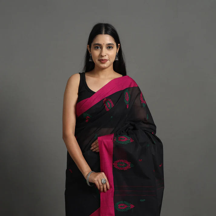 Plumvera model wearing black kanchipuram cotton saree with magenta border and green floral motifs