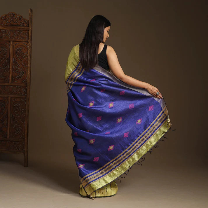 Plumvera model wearing green Tussar silk Bhagalpuri saree with deep purple body and gold border and handwoven motifs back view