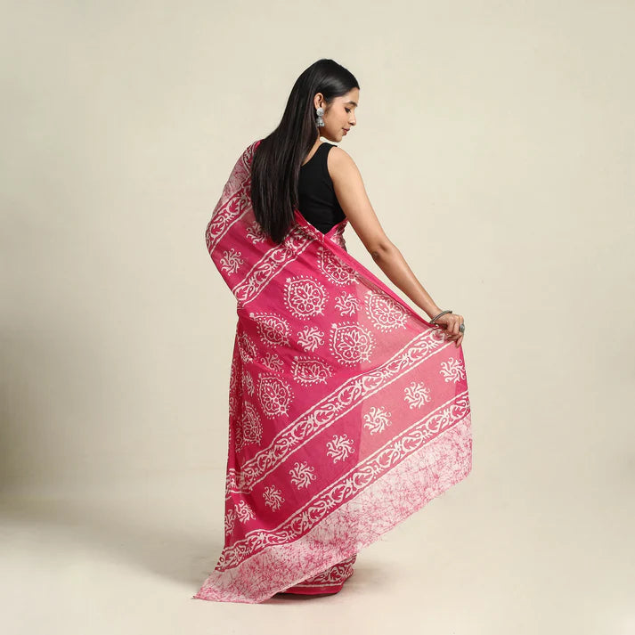 Plumvera model wearing pink batik cotton saree draped with printed pallu and black blouse on neutral background