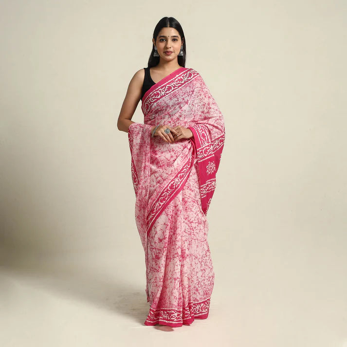 Plumvera pink batik cotton saree draped on model with contrasting black blouse and intricate border print