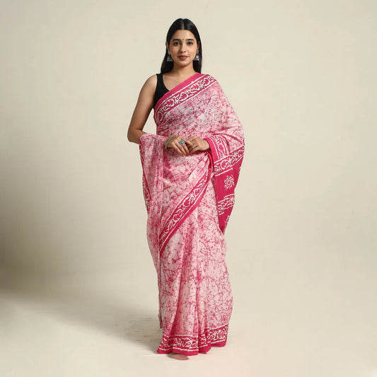 Plumvera pink batik cotton saree draped on model with contrasting black blouse and intricate border print