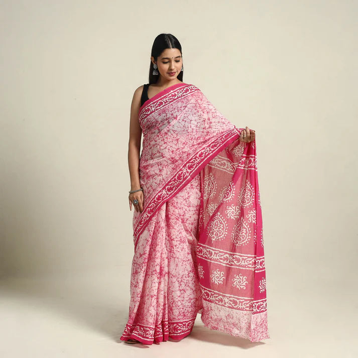 Plumvera model wearing pink batik cotton saree with white floral batik print and deep pink contrast border draped elegantly