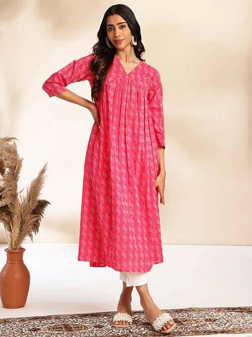 Plumvera model wearing pink cotton gathered kurta with V neckline three quarter sleeves pleated front and white pants