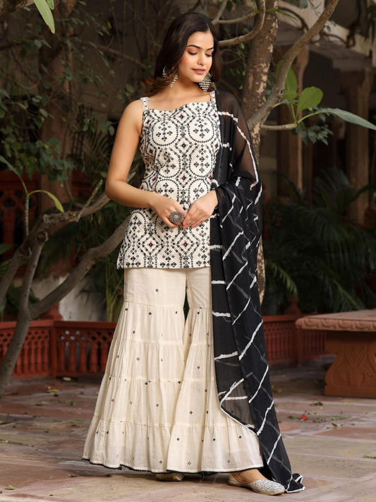 Model wearing Juniper off-white and black embroidered sharara set with sleeveless embroidered kurta and black patterned dupatta